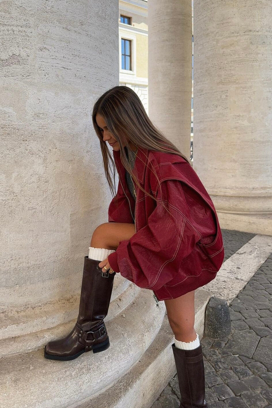 Wine Red Jacket in a model fixing boots